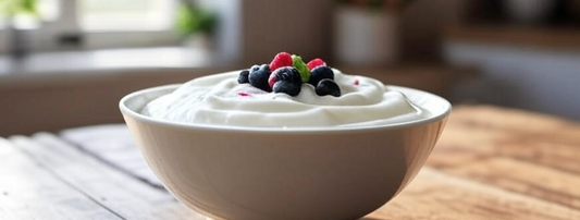 A bowl of Greek yogurt with berries and honey